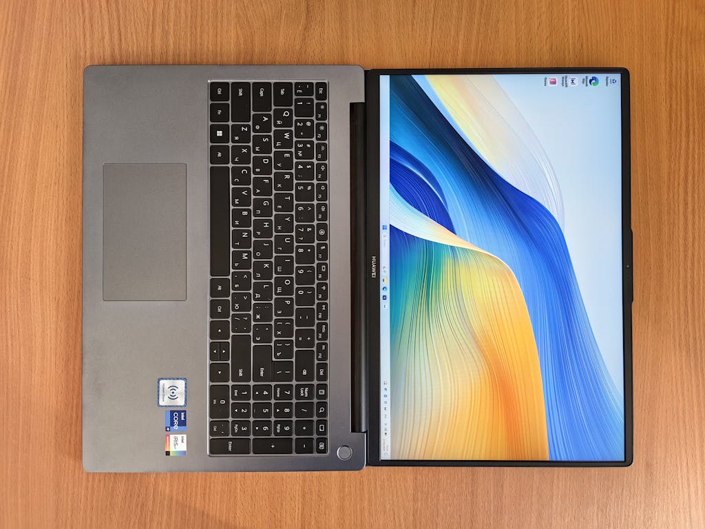 Top view of a modern laptop with an abstract colorful screen. Perfect for technology and workspace themes.